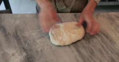 Baker, geleneksel hamur ekmek ve kekleri elle yoğurmaya hazırlanıyor.