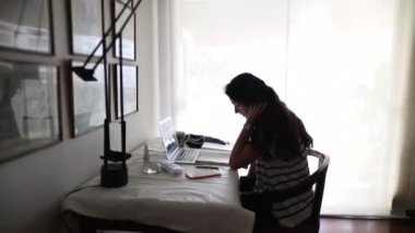 Evde oturan kadın salgın sırasında evden çalışıyor.