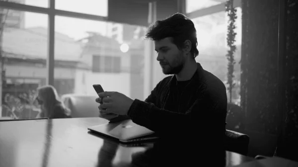 Young Man Coffee Shop Looking Cellphone Using Internet Cafe Monochromatic — Stock Photo, Image