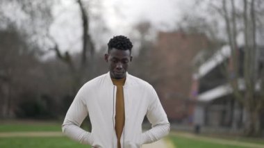 Düşünceli siyah Afrikalı adam parkta yürürken