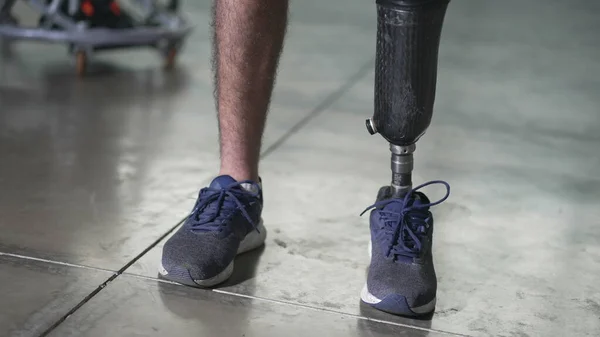 Closeup person wearing a prosthetic leg standing with artificial prosthesis