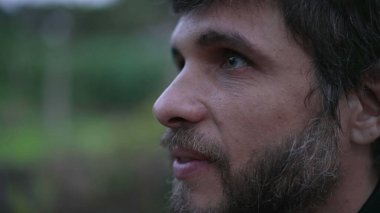 Man looking up at sky smiling having HOPE and FAITH. Person in 30s feeling the presence of GOD feeling FREEDOM