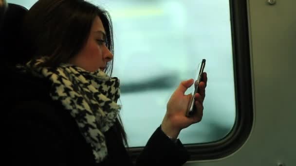 Woman Looks Her Cellphone Tech Device While Train Commute — Stock Video