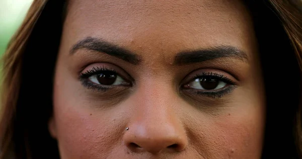 Hispanic woman close-up eyes staring at camera