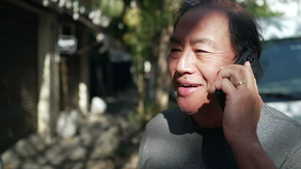 Happy Middle Aged Asian Man Speaking Cellphone Standing Outdoors Street — Fotografia de Stock