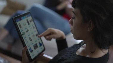 İnternetten ev eşyaları almak için tablet kullanan kişi. Ecommerce sitesine bakan kadın ürünleri karıştırıyor