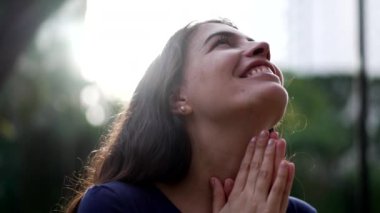 Dua eden ruhani kız dışarıda duruyor. İlahiyete tapan KADIN.