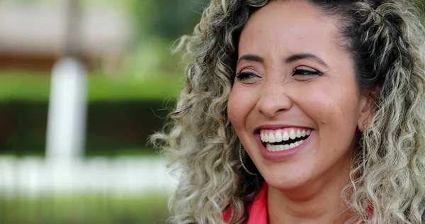 Hispanic woman portrait smiling and laughing, free satisfied person