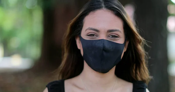 Person wearing covid-19 face mask, hispanic woman wears mask