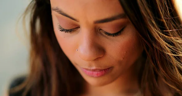 Pensive thoughtful latina young woman looking up thinking