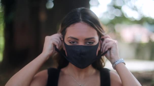 Hispanic Woman Putting Covid Face Mask Looking Camera — Vídeos de Stock