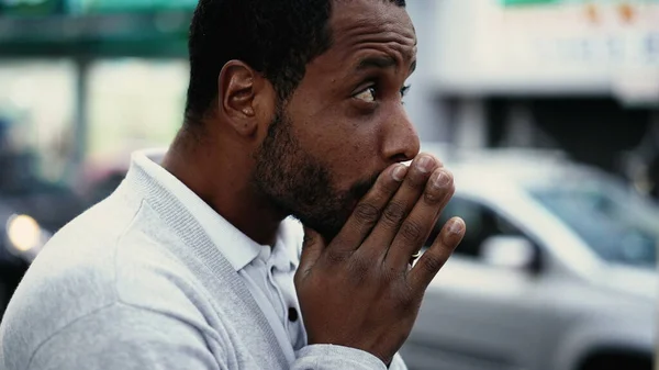 One spiritual young black man praying in street having HOPE and FAITH. African American prays in city urban sidewalk