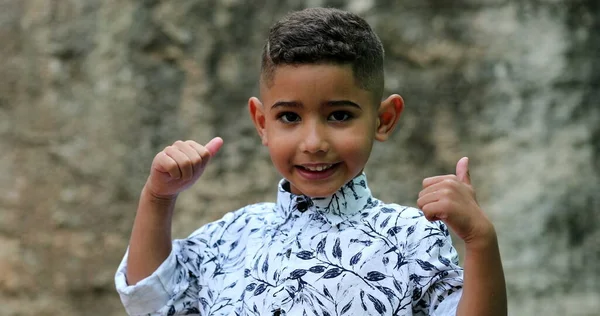 ブラジル人の少年は親指をあきらめた ヒスパニック系の子供は正の信号を — ストック写真