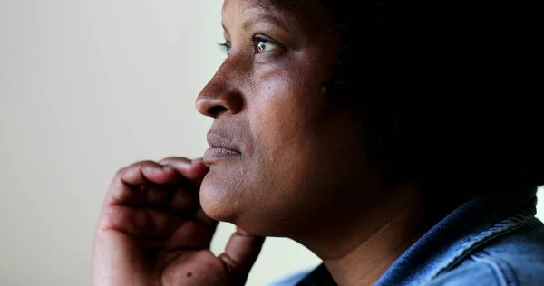 Pensive black woman close-up face. candid contemplative person thinking about decision