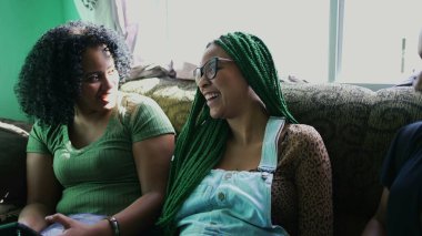 Siz siyahi Latin arkadaşlar, birlikte kanepede oturup gülüyor ve gülüyorsunuz.