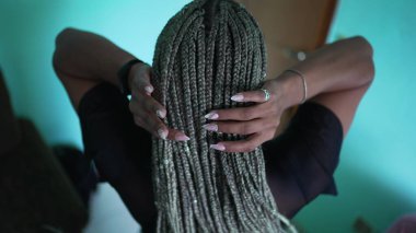 A black latina girl with box braids hairstyle
