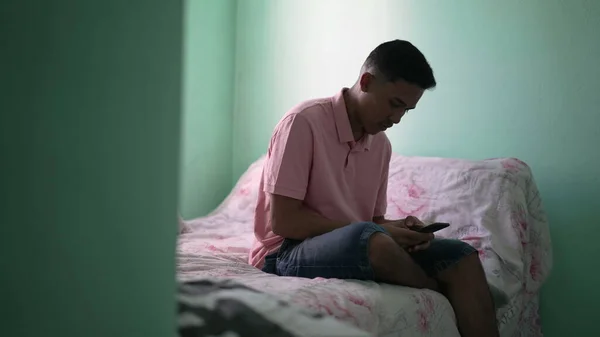 One Young Hispanic Man Looking Cellphone Device Sitting Bed Bedroom — Stock Photo, Image