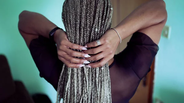 One young latina woman showing her braided hairstyle. Girl shows her box braids hair2