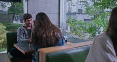 Arkadaşlar kahve dükkanında toplandı. Kafe restoranında oturan farklı bir grup insan konuşuyor.