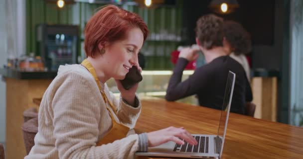 ノートパソコンの前で働く若い女性です 女性の仕事 小規模なビジネスコーヒーショップ — ストック動画
