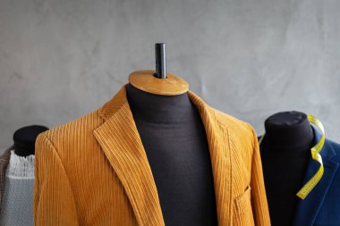 Terzi mankeni ve mezura üzerindeki takım elbise ceketi. Giysi mağazası iş yeri kavramı