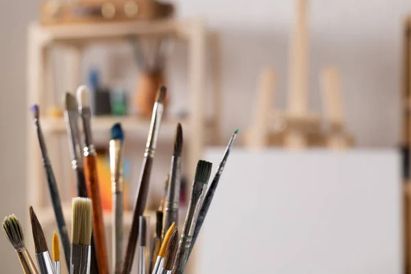 Paint brush and art painter tools on wood background. Paintbrush for painting in artist studio workplace