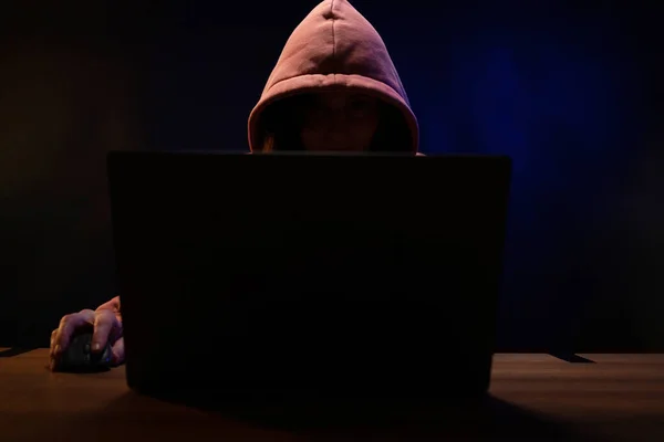 Bilgisayarda çalışan bilgisayar korsanı kadın. Karanlık oda arka planında Hacker saldırısı