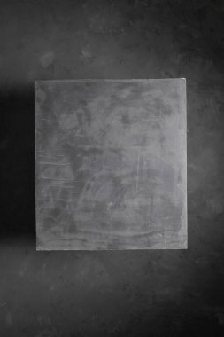 Concrete cube at abstract cement floor background texture. Geometric model concept