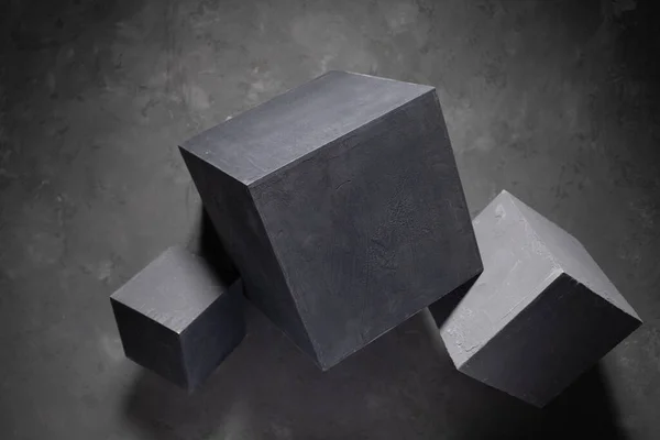 Concrete cube at abstract cement floor background texture. Geometric model concept