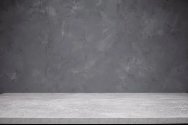 Front view of tabletop near grey wall. Top table and concrete background