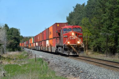 Locomotive approaching with bright blue sky