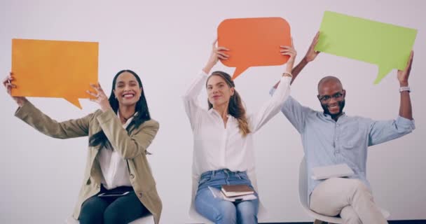 4k video footage of a group of young business people holding up chat bubbles — Stok video