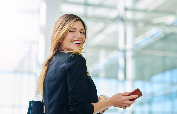 Follow me to the office. Cropped portrait of an attractive young businesswoman smiling while walking through a modern office. —  Fotos de Stock