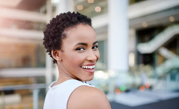 Yup, dreams do come true. Cropped portrait of an attractive young businesswoman smiling while standing in a modern workplace. — Fotografia de Stock