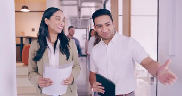 4k video footage of a young businessman welcoming a female colleague into his office — Wideo stockowe