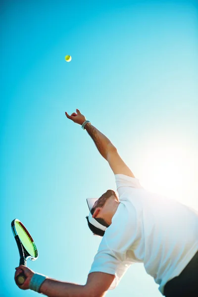 You got served. Low angle shot of a sporty young man playing tennis. — Stock Photo, Image