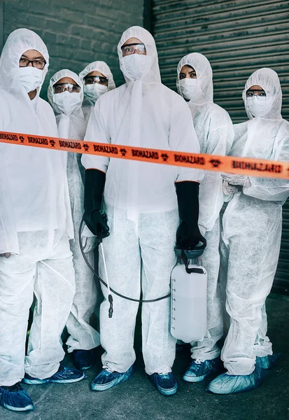 Η ομάδα καταπολέμησης του ιού. Πυροβολισμός ομάδας εργαζομένων στον τομέα της υγειονομικής περίθαλψης που φορούν στολές κινδύνου και συνεργάζονται για τον έλεγχο μιας επιδημίας. — Φωτογραφία Αρχείου
