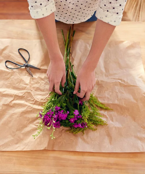 Faire un bouquet joyeux. Plan recadré d'une jeune femme arrangeant des fleurs à la maison. — Photo