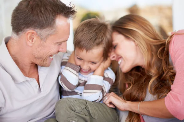 Beware the tickle monster. Shot of parents tickling their young son. — Stock Photo, Image