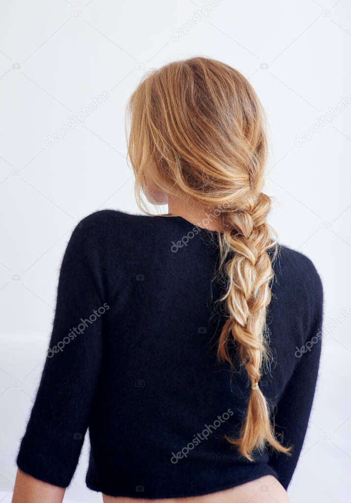Back to the basics. Rearview shot of woman with a plaited hairstyle.