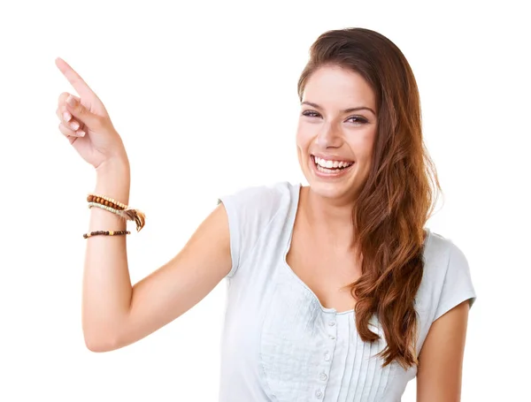 This is funny. Portrait of a smiling young woman pointing at copyspace. — Stock Photo, Image