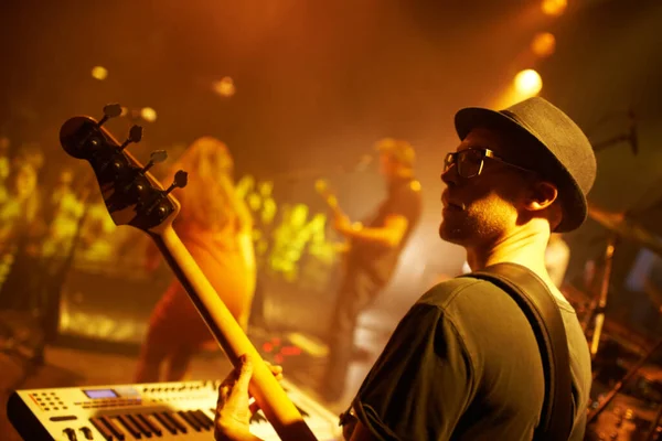 Playing to the adoring fans. Shot of a band playing at a music festival- This concert was created for the sole purpose of this photo shoot, featuring 300 models and 3 live bands. All people in this — Stock Photo, Image