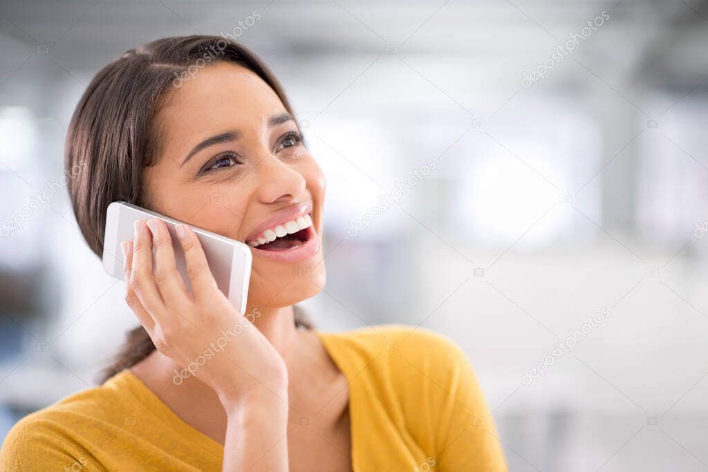 Thats great news. Cropped shot of an attractive young businesswoman talking on a cellphone.