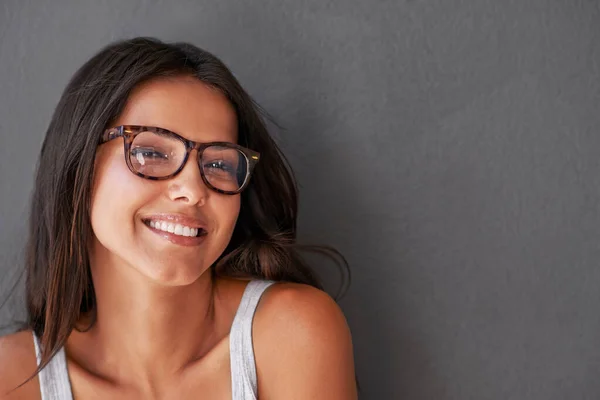 Shes got such a beautiful personality. Studio shot of an attractive young woman wearing glasses. — Stock Photo, Image