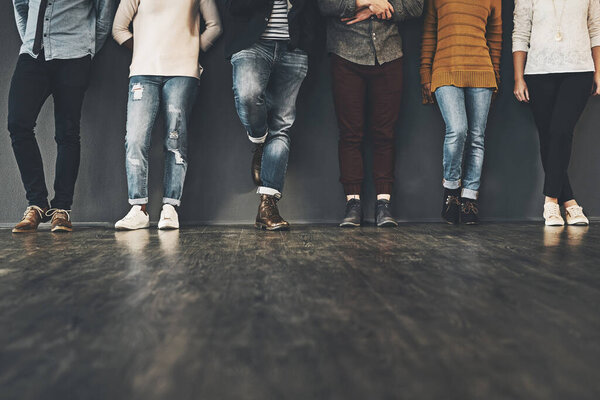 Be trendy in your stance. Studio shot of a group of unrecognizable people standing against a grey background.