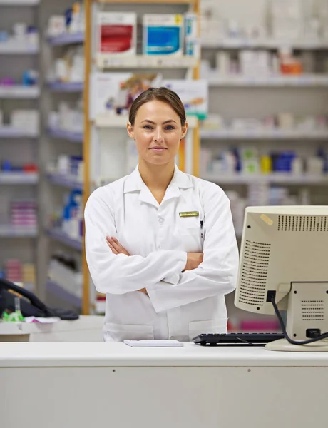 Treatments begin with her. Portrait of an attractive young pharmacist standing at the prescription counter. — Stock Photo, Image