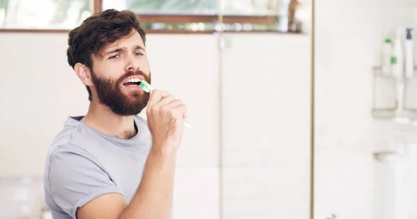 Keep it fresh, look your best. Shot of a handsome young man singing while brushing his teeth at home. — Stock Photo, Image