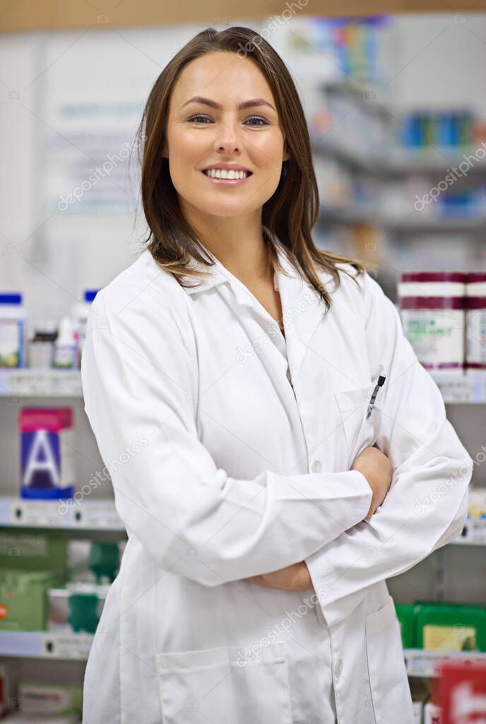 Friendly and knowledgable. Portrait of an attractive young pharmacist at work.