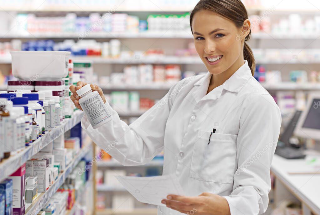 Providing perfect prescriptions. Shot of an attractive young pharmacist checking stock in an aisle.