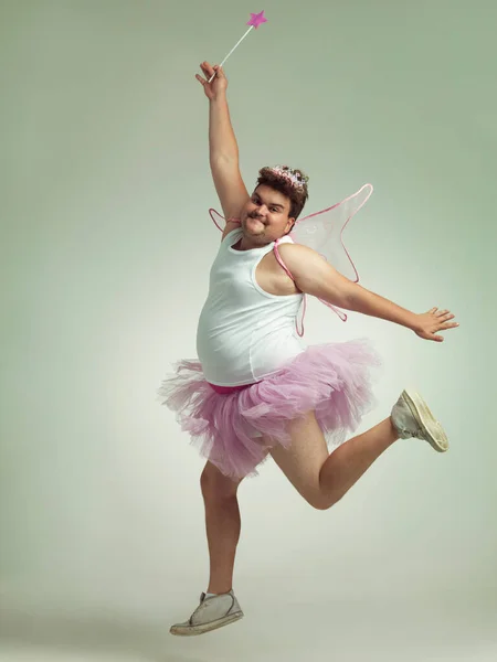 Showing his "lighter" side. An overweight man comically dressed-up in a pink fairy costume. — Stock Photo, Image